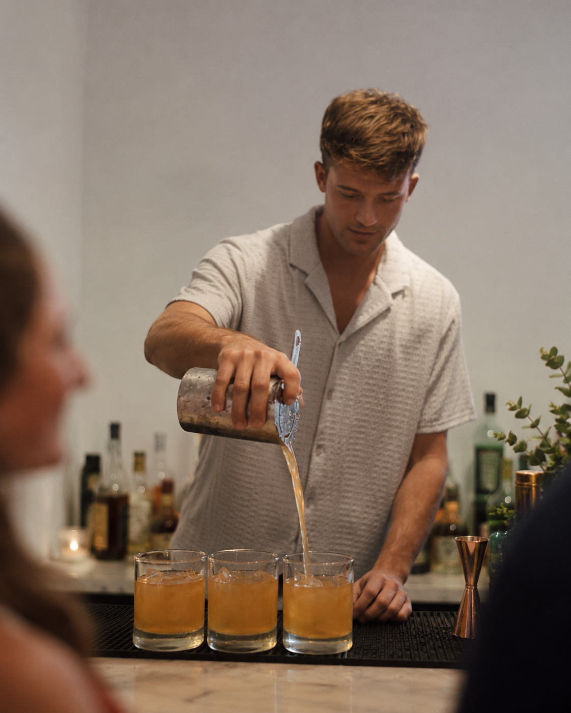 Bartender pouring cocktails at an event